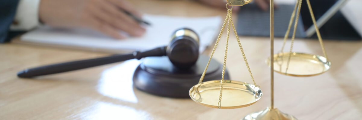 Concept of justice, Lawyer holding a hammer pretending to hit on Concept of justice, Lawyer holding a hammer pretending to hit on a wooden tray put on the desk.